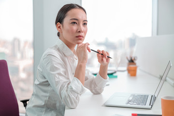 Asian woman is working in office