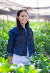 Portrait of asian female farmer smiling at the camera.