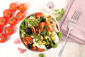bowl of vegetable salad with bean, tomato, egg and olive