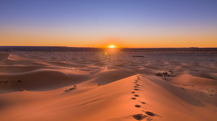 Fototapeta na wymiar A lovely sunrise at the Sahara Desert in Morroco. A asthonishing view after a night at thr desert