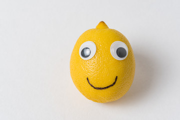 funny lemon fruit character. Ripe lemon with eyes and smile. creative idea.