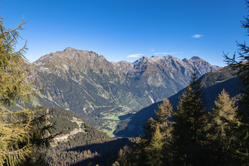 Panorama view of Swiss Alps in Grisons and aerial view of the Val Mesolcina valley and Mesocco town, on a sunny summer day on the Sentiero - Calanca hiking trail in Canton of Graubuenden, Switzerland