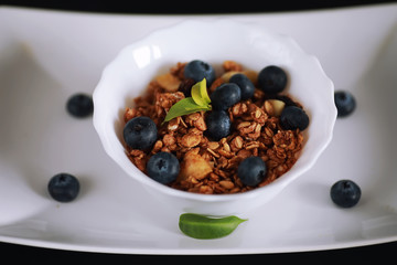 A healthy breakfast cereal with milk and fruit. Oat and corn flakes with chocolate and yogurt. The concept of healthy and vegetarian food.