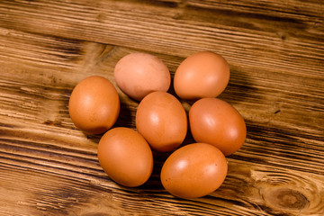Pile of the hen eggs on wooden table