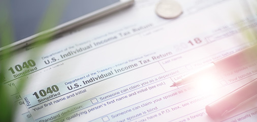Fototapeta premium Annual tax reporting. Tax form on the table. Financial statements for signature.