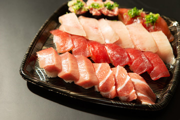 Assorted tuna sushi pack on black background 