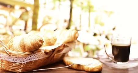 Fresh pastries on the table. French flavored croissant and coffee.