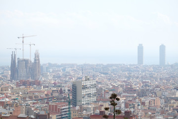 Fototapeta na wymiar View of Barcelona from Parc Guëll with the Sagrada Familia, Twin towers and the Mediterranean Sea