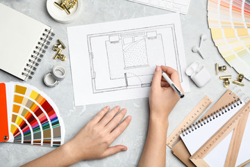 Interior designer planning bedroom at marble table, top view