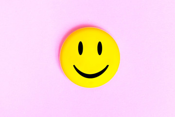 Positive Funny smiley face on a pink cardboard background. Copy space for advertising and texts