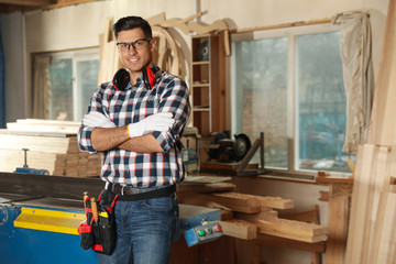 Professional carpenter with set of tools in workshop