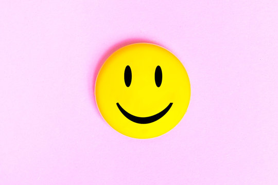 Positive Funny smiley face on a pink cardboard background. Copy space for advertising and texts