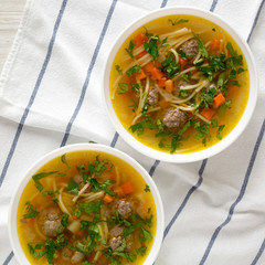 Homemade Sopa a La Minuta in white bowls on a white wooden surface, top view. Flat lay, overhead, from above. Close-up.