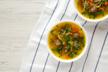 Homemade Sopa a La Minuta in white bowls on a white wooden background, top view. Flat lay, overhead, from above. Space for text.