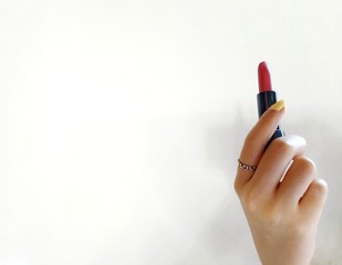 hand with pencil and eraser on white background