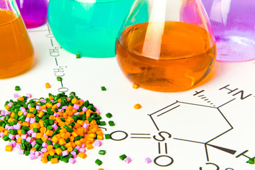 Plastic raw material in granules against the background of Chemical Laboratory and reagents. Polypropylene, Ethylene, Polypropylene research in laboratory conditions