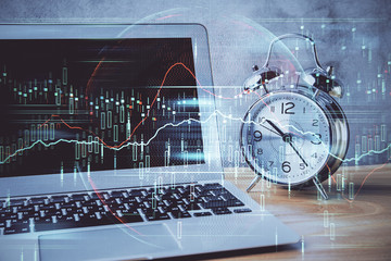 Double exposure of chart and financial info and work space with computer background. Concept of...