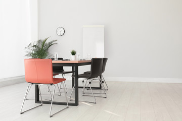 Simple office interior with large table and chairs