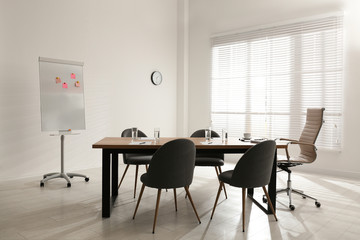 Simple office interior with large table and chairs