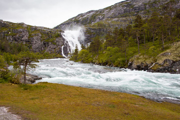 Giant waterfall of Husedalen valley and Hardangervidda National Park. The trail through Husedalen valley is one of the most beautiful hikes in Norway.