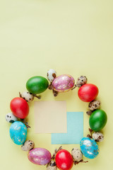 Top view painted eggs Easter Frame in circle shape on a yellow background. Copy space