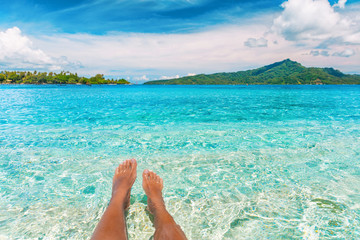 Relax feet selfie woman lying in turquoise crystalline blue water on French Polynesia motu beach...