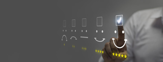 Businessman pressing smiley face emoticon on virtual touch screen. Customer service evaluation...