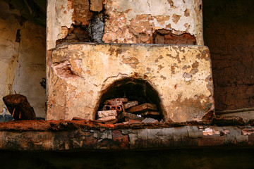 Interior view of a collapsed house and the shattered chimney with bricks in the hollow