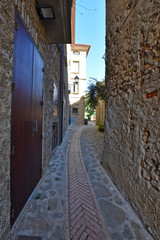 Fototapeta na wymiar Acciaroli, Italy, 02/15/2020. A narrow street between the old houses of a village in southern Italy