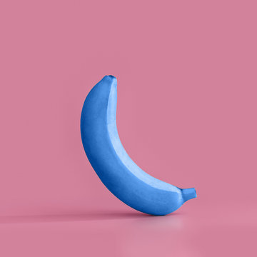 Juicy ripe blue banana on a pink pastel background. Minimal concept.