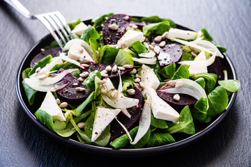  Beetroot salad with goat cheese on black stone plate