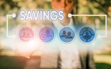 Conceptual hand writing showing Savings. Concept meaning the money that a demonstrating keeps in an...