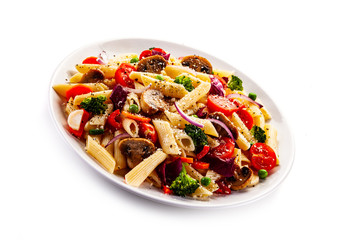 Penne with meat and vegetables on white background