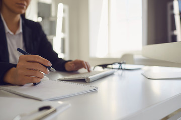 Work in the office at the computer. Business woman's handless face is typing on a computer keyboard.