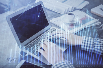 Double exposure of forex graph with man working on computer on background. Concept of market analysis.