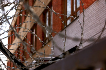 Barbed wire on the background of the detention center