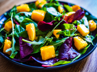 Mango with vegetables on wooden table