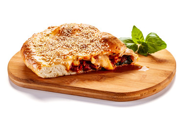 Pizza calzone on cutting board on white background