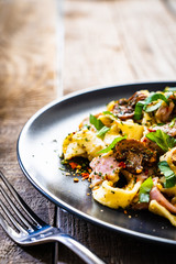 Tagliatelle with ham and chmpignon wooden table