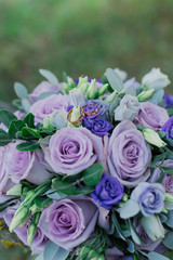 New wedding rings next to the bride's bouquet.