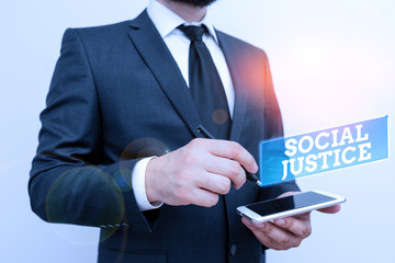 Text sign showing Social Justice. Business photo text Equal access to wealth and privileges within a society Male human wear formal work suit hold smart hi tech smartphone use one hand