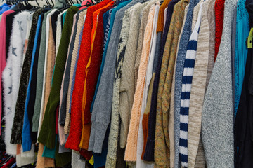 Beautiful clothes on hangers in a stylish store.