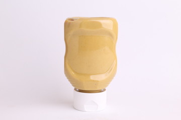 pot of mustard sauce in color background