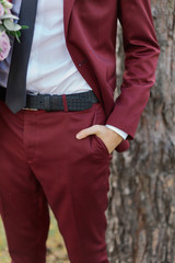 Young businessman man holds hand in trouser pocket.