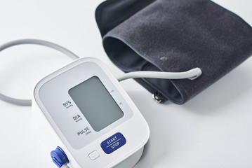 Digital blood pressure monitor on the table, closeup. Helathcare and medical concept