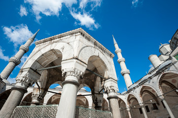 Minarets frame the hexagonal ablution fountain in the center of an arched courtyard of the Blue...