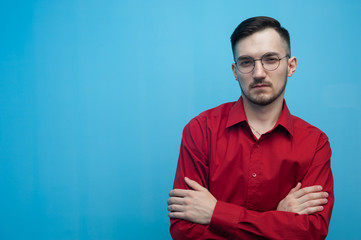 Fototapeta premium Young man in glasses and a burgundy shirt