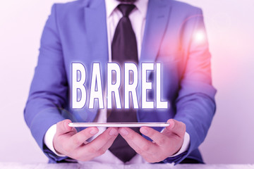 Word writing text Barrel. Business photo showcasing cylindrical container bulging out in the middle made of wooden staves Businessman in blue suite with a tie holds lap top in hands