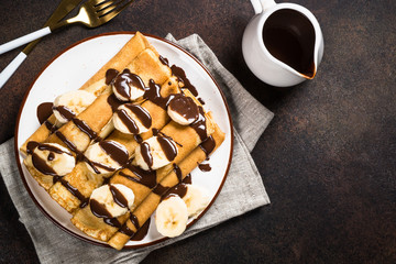Crepes with chocolate and banana top view.