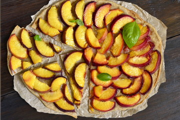 Crostata with peaches and fresh basil, tart, flat lay